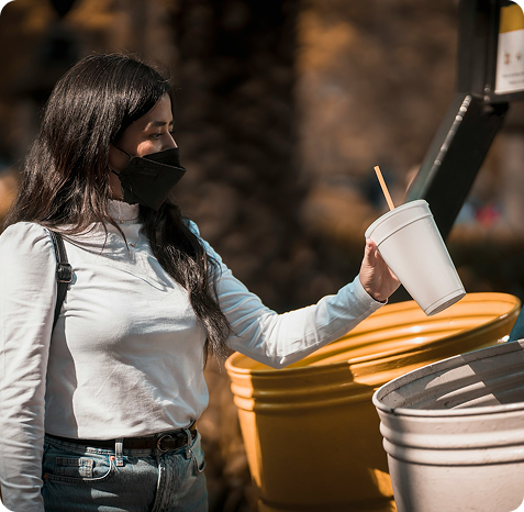Person using recycling bins